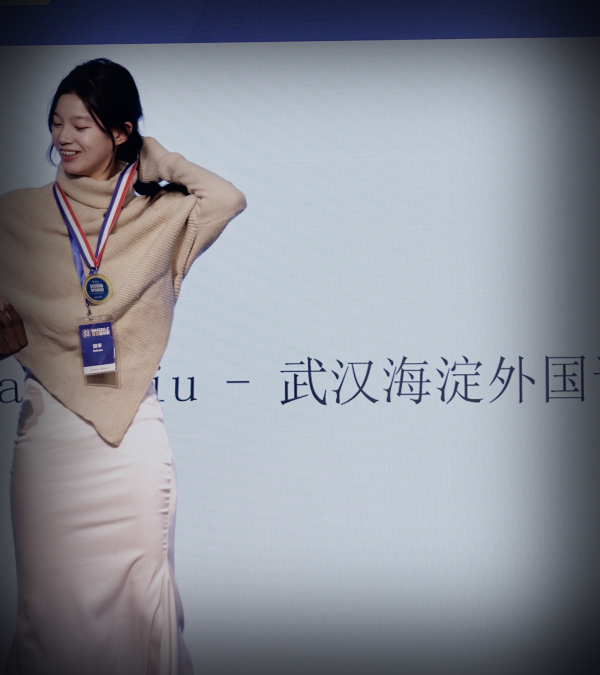 Stephanie Liu receiving a speaking award on stage